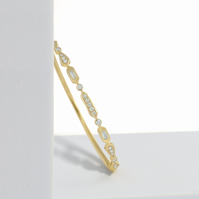 and diamond bangle leaning on a white block