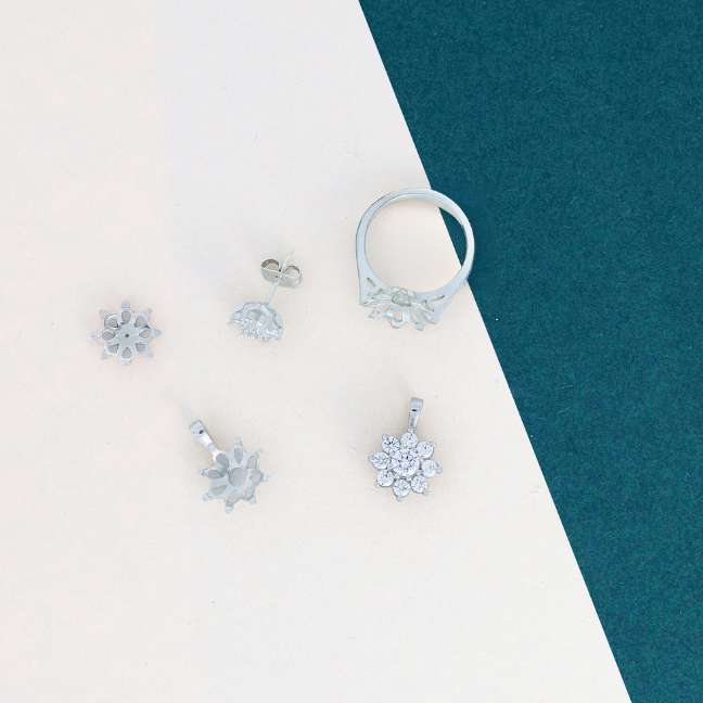 jewellery components scattered on cream and green card