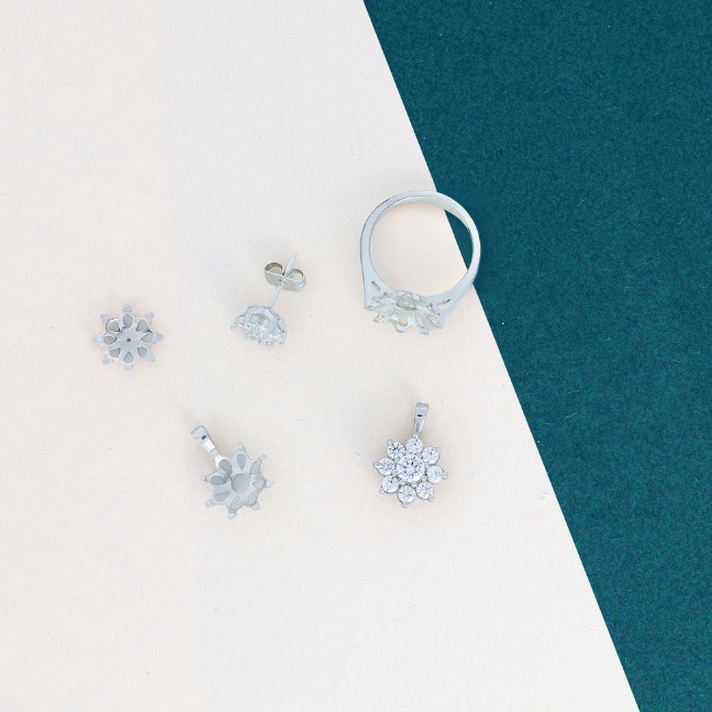 jewellery components scattered on cream and green card