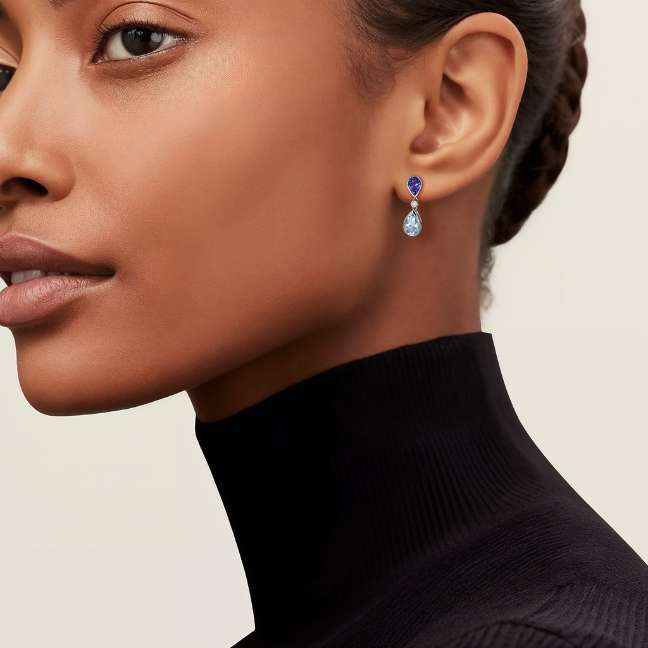 lady wearing blue topaz and aquamrine earrings
