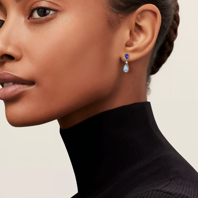 lady wearing blue topaz and aquamrine earrings